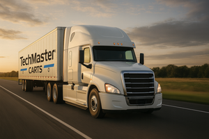 Truck with TechMaster Carts branding on a road at sunset.
